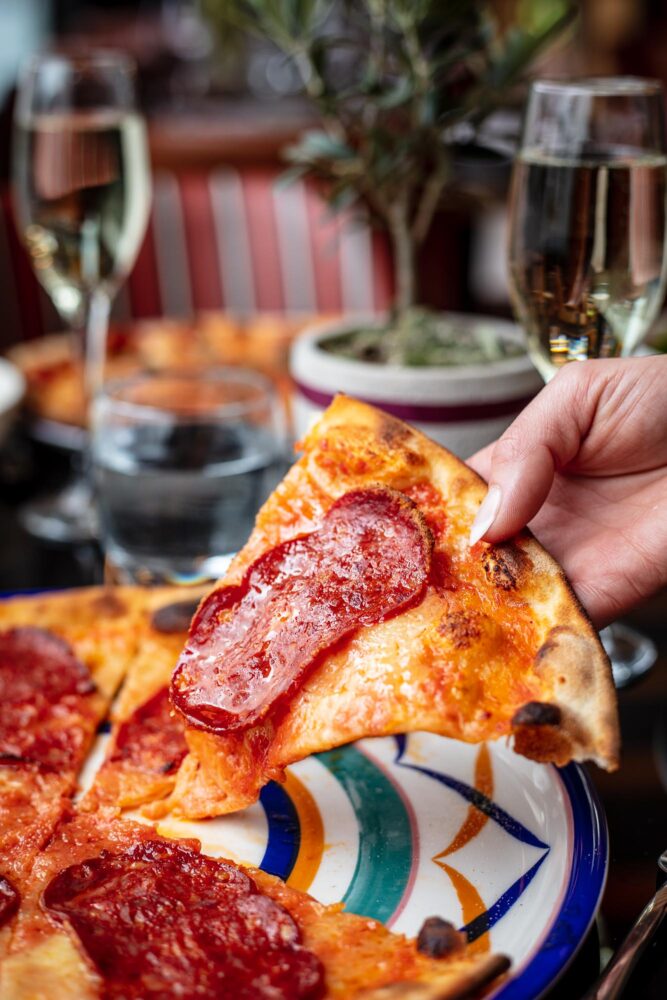 Women taking pizza slice