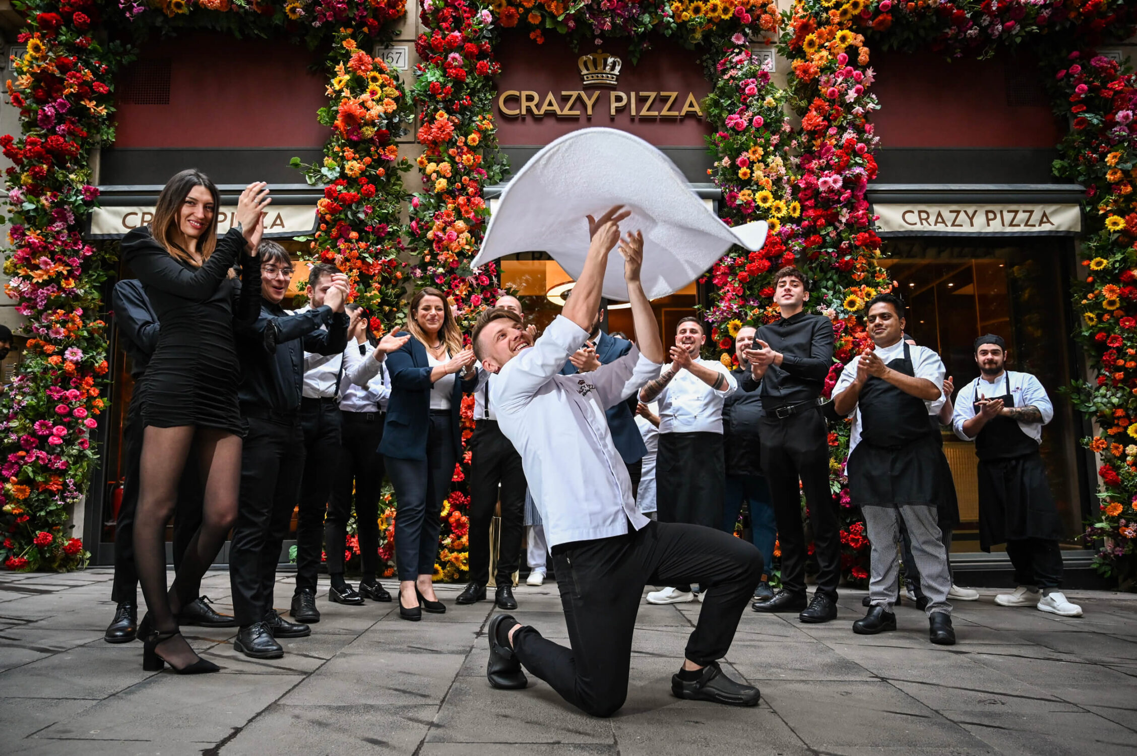Chef Tossing Pizza Outside Crazy Pizza