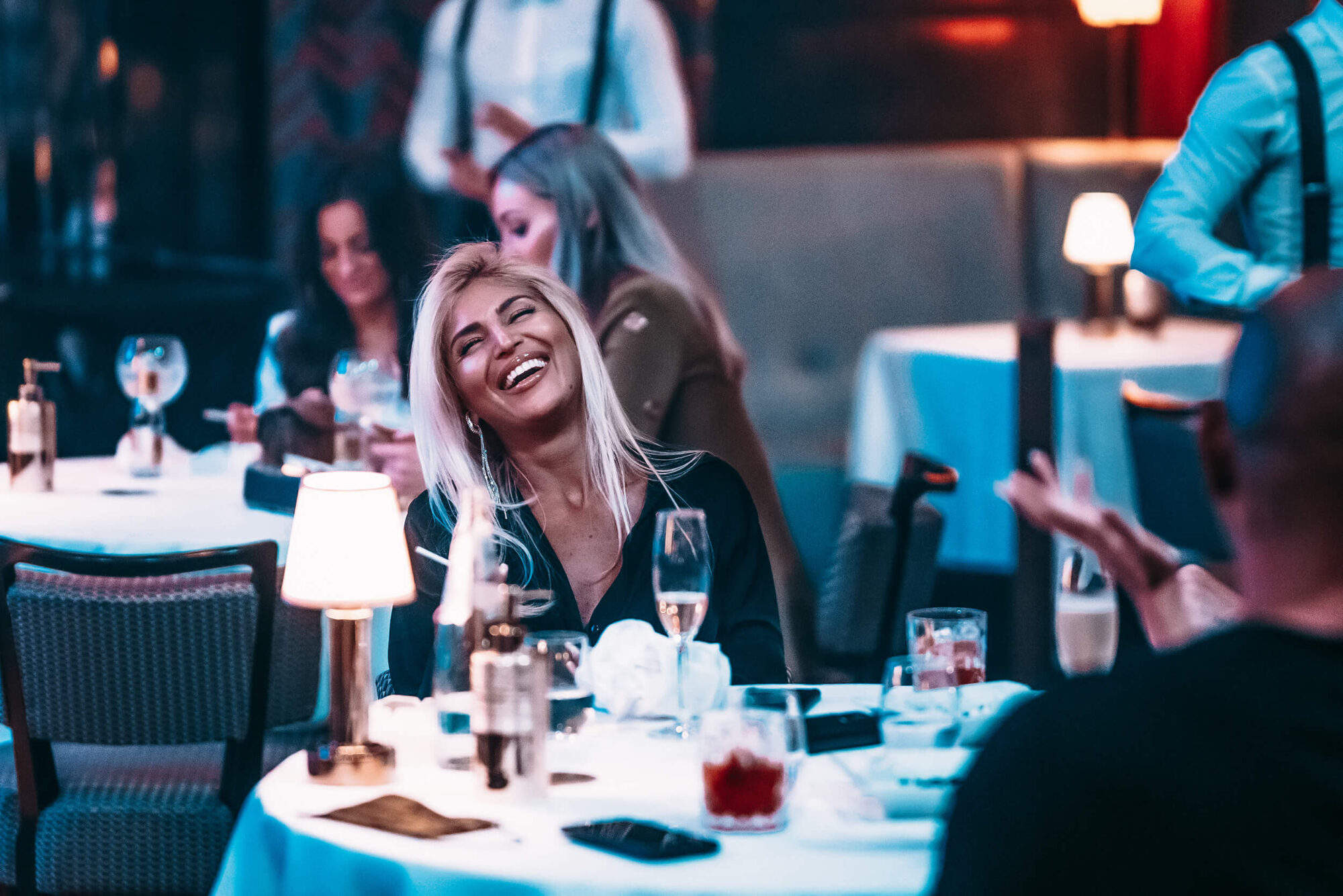 Girl laughing at table Billionaire