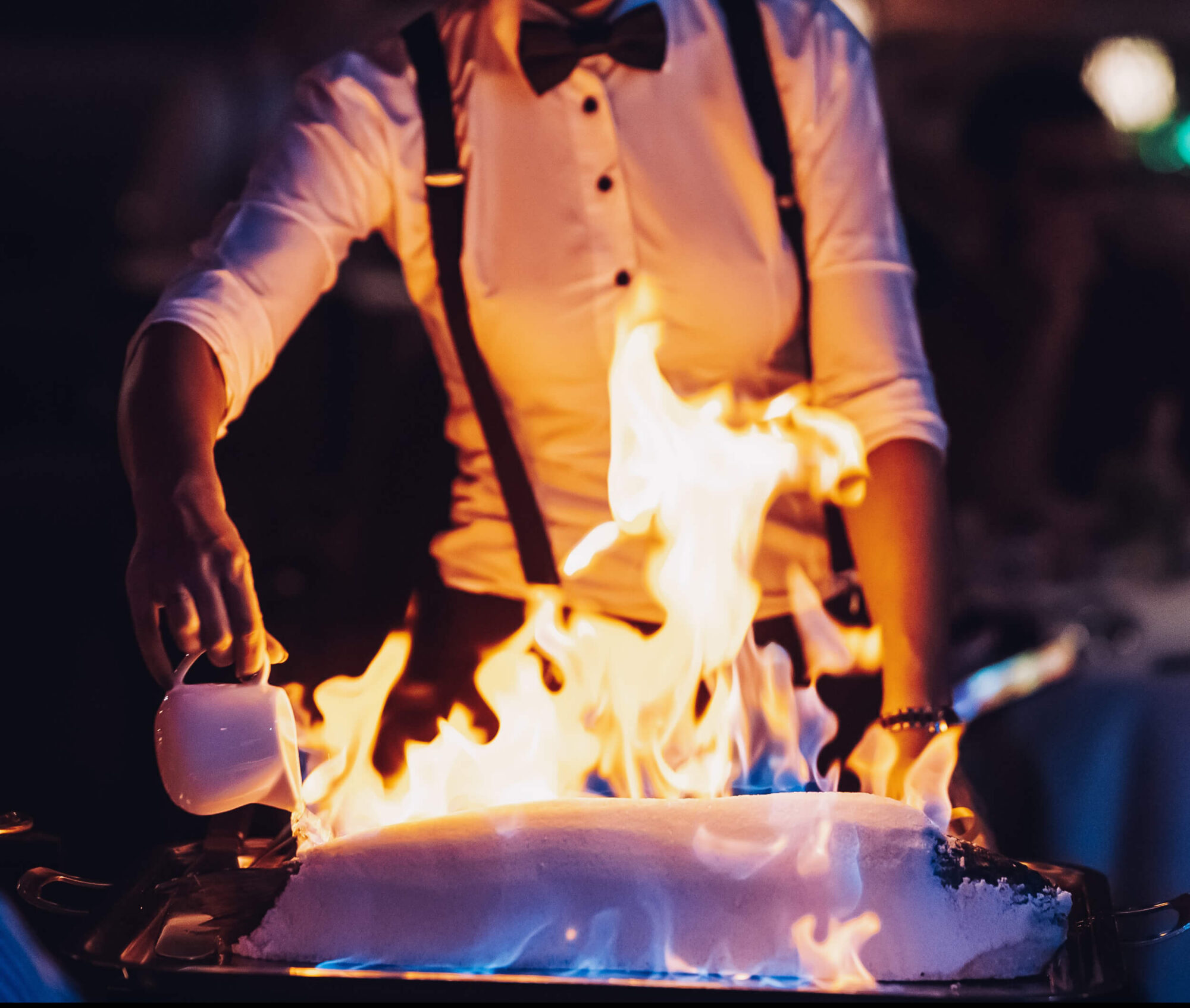 Chef cooking sea bass with flame